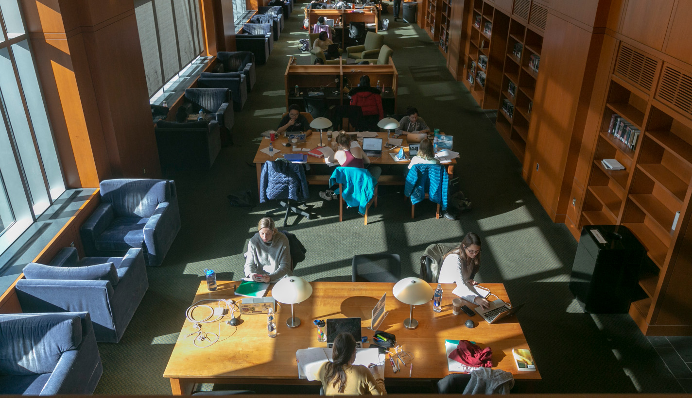 Students working at community tables in a Duke library.