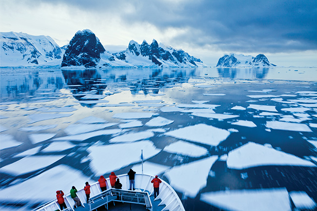 Antarctica view of broke ice across the water with group of onlookers