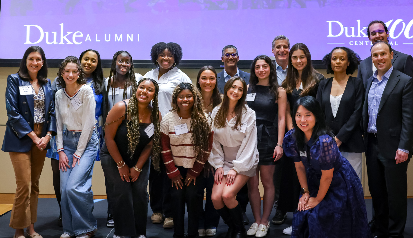 Group of students and alumni posing for the camera.