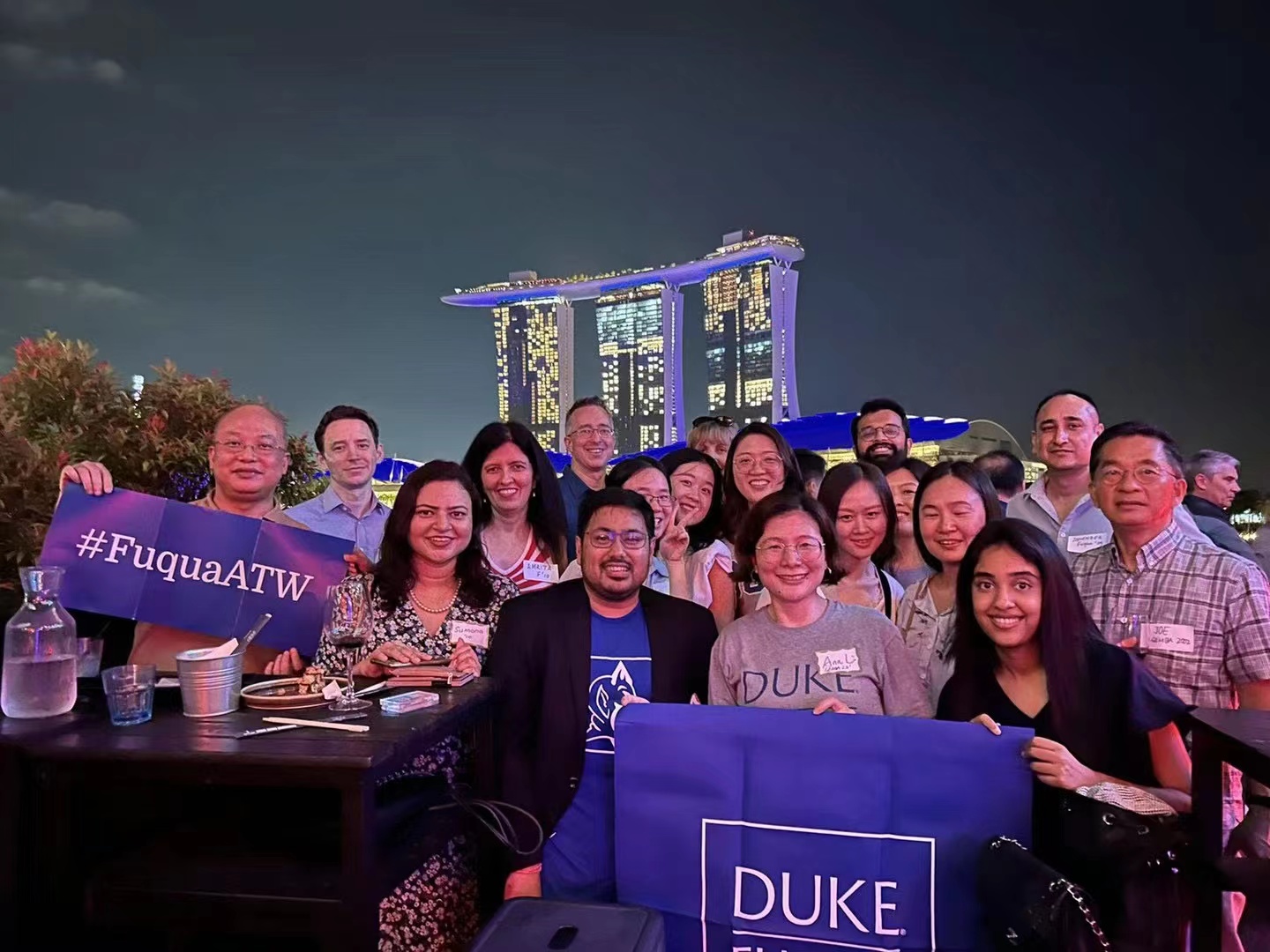 #FuquaATW participants posing for a group photo with the Singapore skyline in the background.