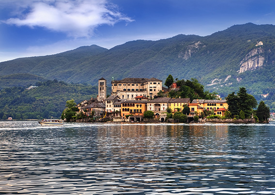 Lake Orta with building in the background along with mountains
