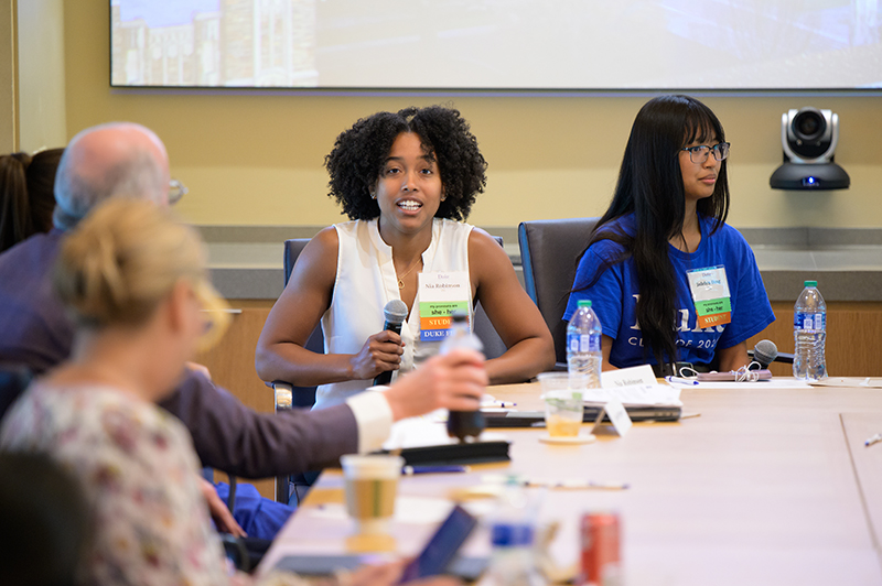 Woman talking surrounded by other people at a Duke event.