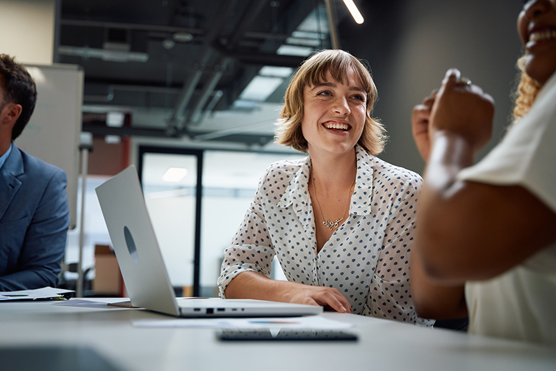 Woman smiling near laptop