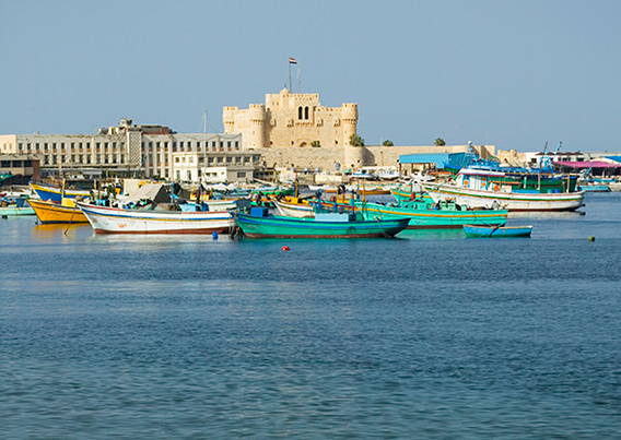 Danita Delimont water way with boats and building in the background.