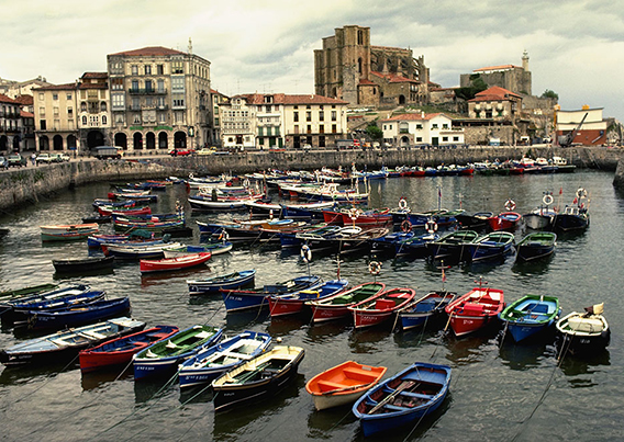 colorful boats parked side by side on the water