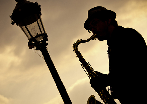 Man in hat playing saxaphone