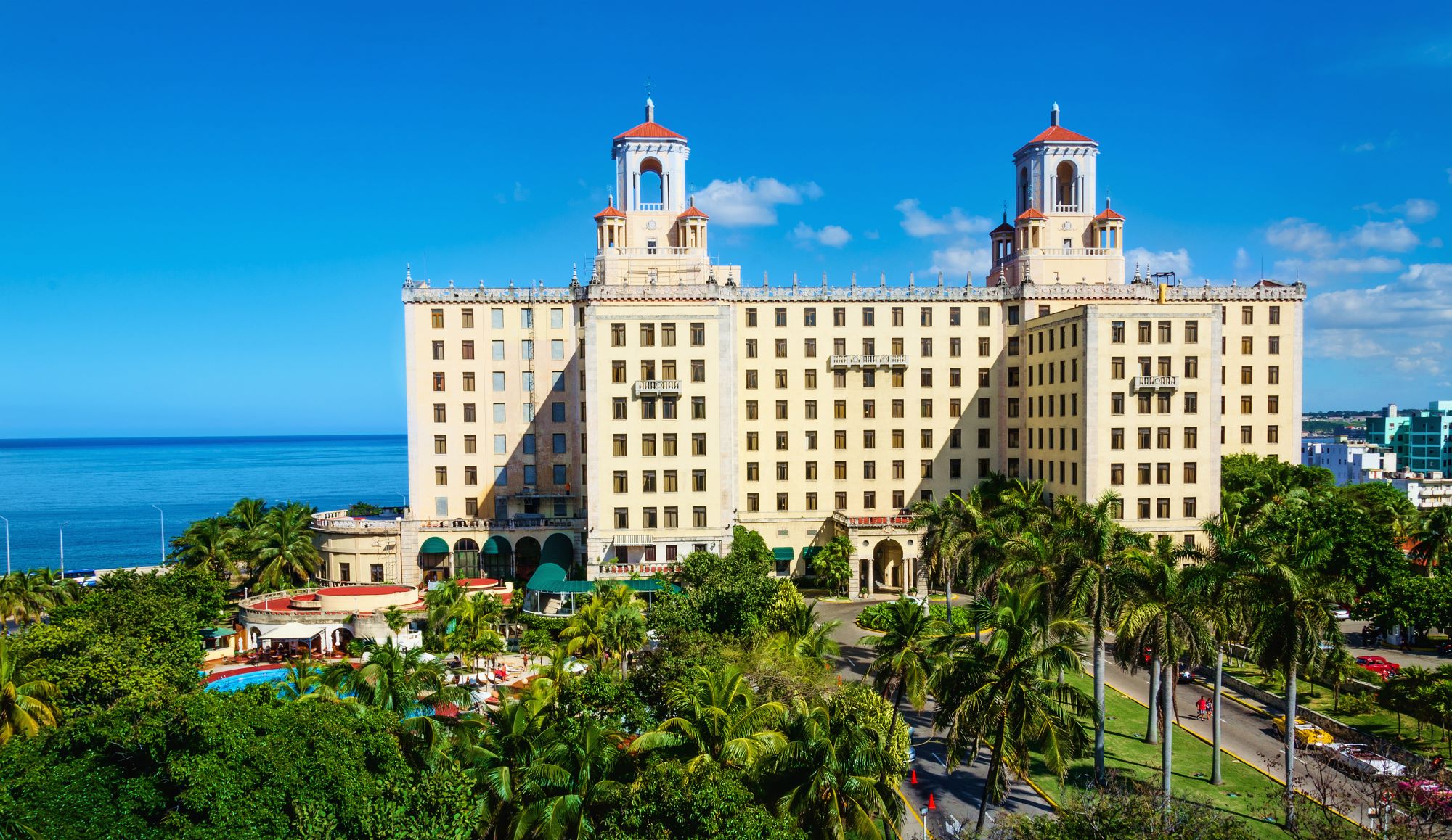 View of Hotel Nacional among green palm trees in Havana